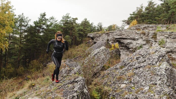 female-sporty-jogger-running-stones-long-shot