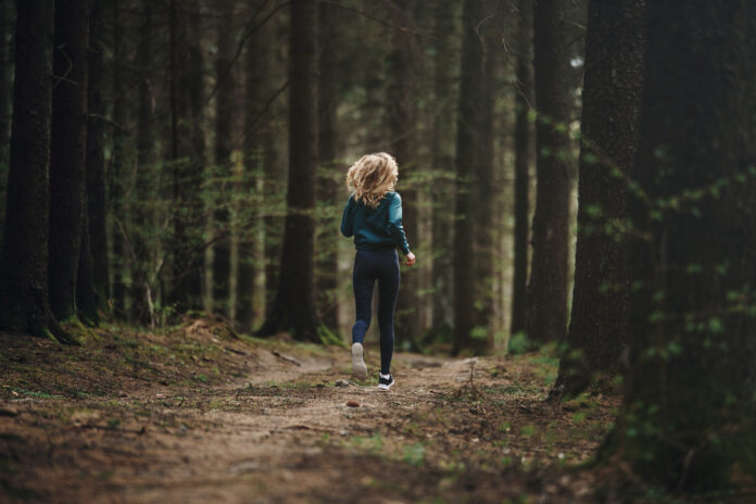 rear-view-full-length-woman-running-forest
